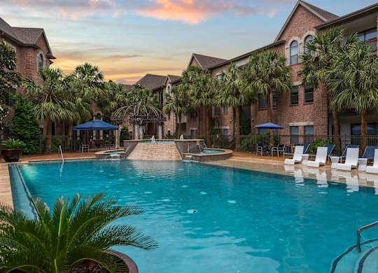 Resort style pool with palm trees and courtyard at Melia Medical Center Apartments, Houston, TX