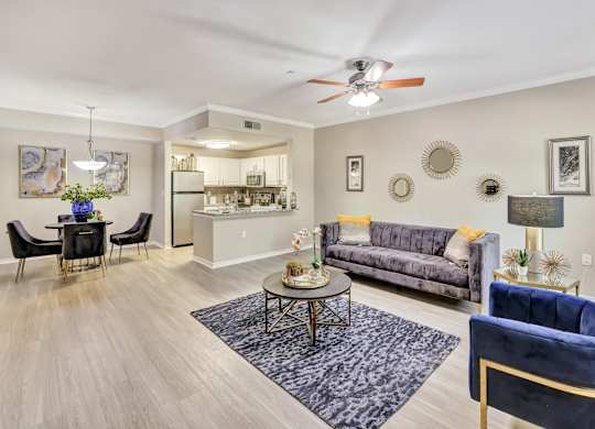 A living room with a grey sofa and a blue armchair.