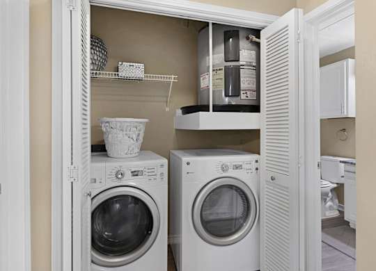 A white laundry room with a washer and dryer.