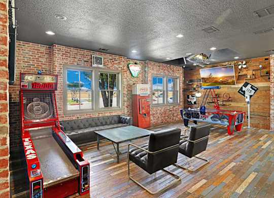 A room with a bowling alley and a pool table.