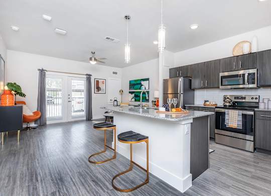 Open floor plan with kitchen island and pendant lighting at Sienna at Westover Hills Apartments, San Antonio, TX 78253