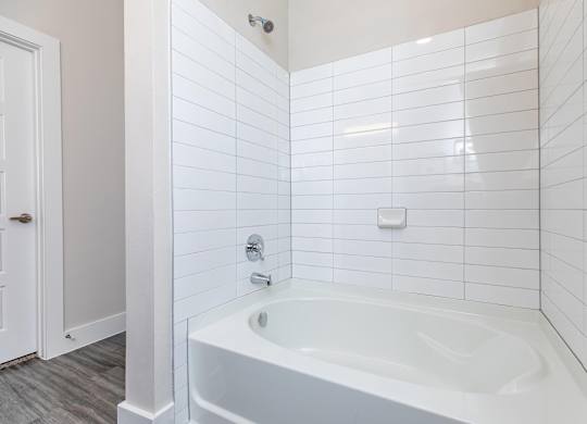 White subway tile bathtub with chrome fixtures at Sienna at Westover Hills Apartments, San Antonio, 78253