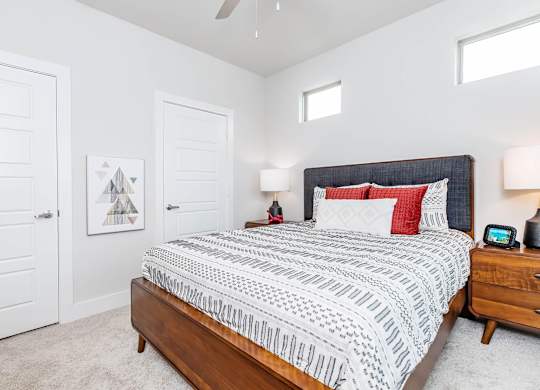 Bedroom with upholstered headboard and geometric patterned bedding at Sienna at Westover Hills Apartments, San Antonio, TX