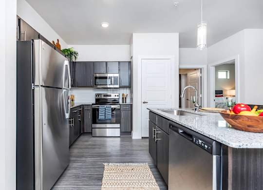 Kitchen with stainless appliances and island at Sienna at Westover Hills Apartments, Texas