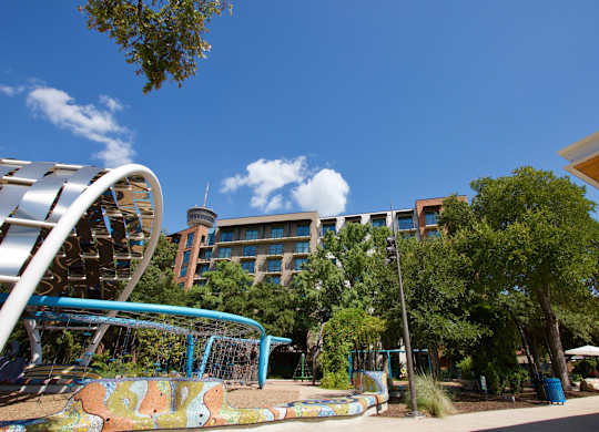 Outdoor playground area with modern climbing equipment at THE'68 Apartments, San Antonio, 78205