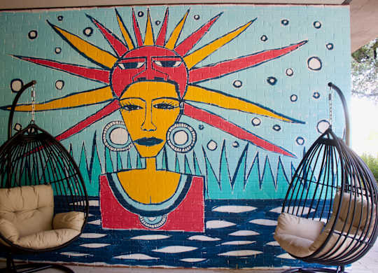 Colorful mural with hanging egg chair seating at THE'68 Apartments, Texas, 78205