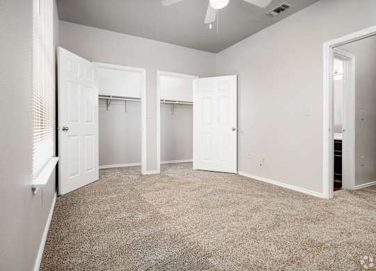 Spacious bedroom with dual walk-in closets at Houston Street Townhomes Apartments, San Antonio, 78220