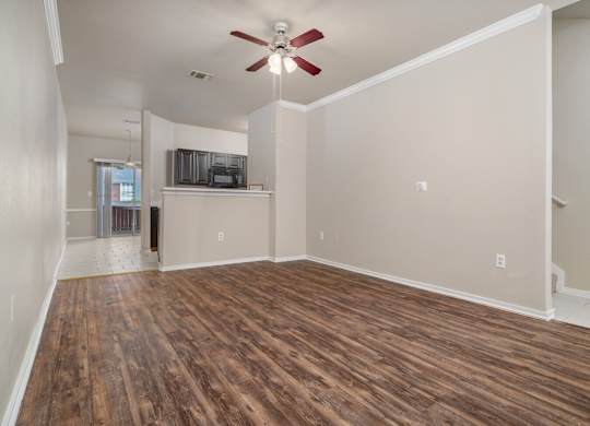 Open living and dining area with wood flooring at Houston Street Townhomes Apartments, Texas, 78220