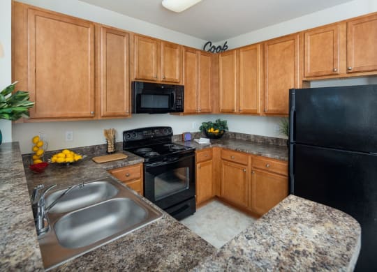 Kitchen With Sink, Refrigerator And Modern Appliances at Abberly Village Apartment Homes by HHHunt, South Carolina, 29169