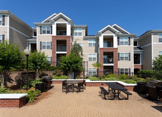 Garden Courtyard With Grills And Fireplace at Abberly Village Apartment Homes by HHHunt, South Carolina, 29169
