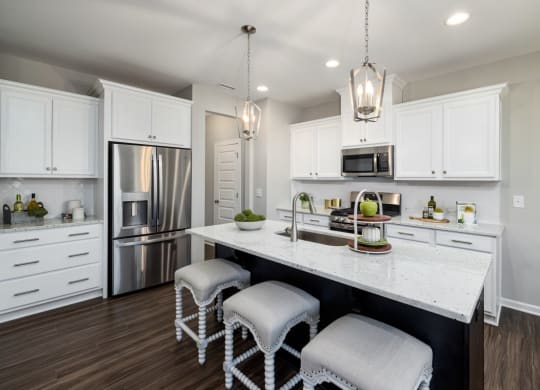 a kitchen with white cabinets and a white countertop