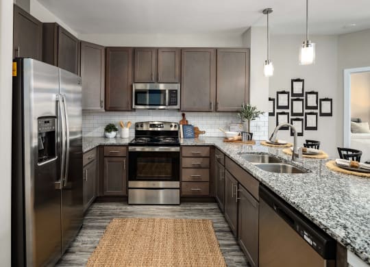a kitchen with stainless steel appliances and granite countertops