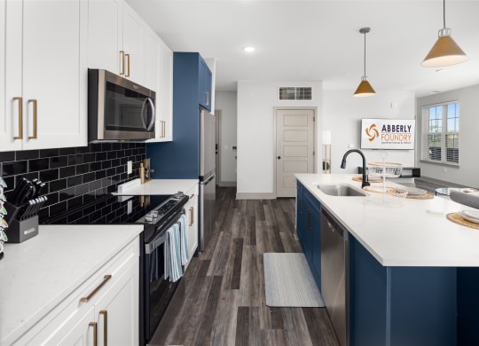 a kitchen with white countertops and blue cabinetsat Abberly Foundry Apartment Homes, Nashville