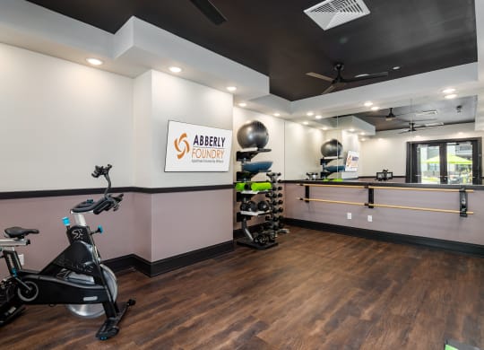a gym with exercise equipment and a counter with a sink at Abberly Foundry Apartment Homes, Nashville, 37203