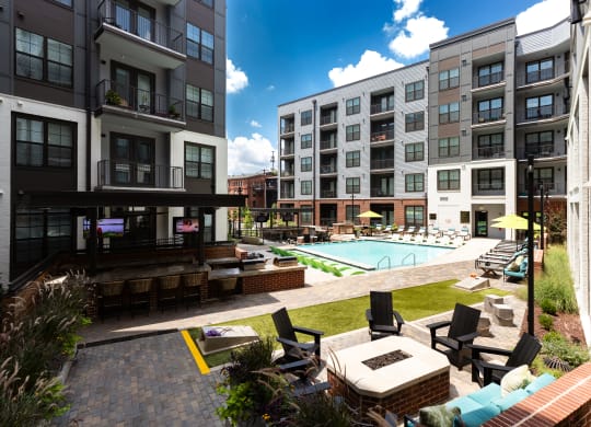 an outdoor lounge area with lounge chairs and a fire pit at the bradley braddock  at Abberly Foundry Apartment Homes, Nashville