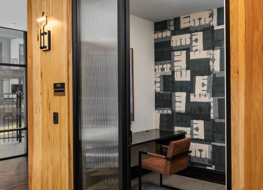 a meeting room with a wooden wall and a glass door at Abberly Foundry Apartment Homes, Nashville, TN, 37206