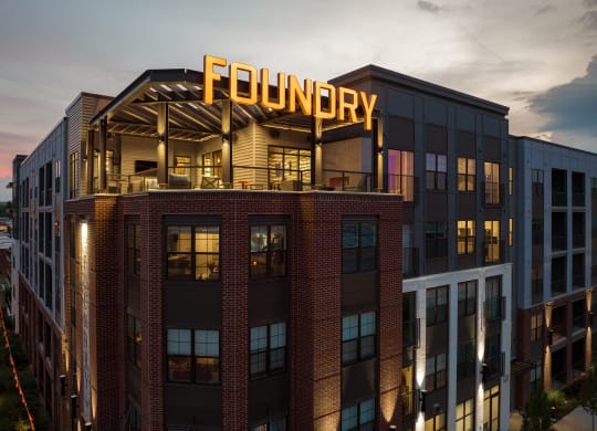 a rendering of the exterior of the foundry building at dusk at Abberly Foundry Apartment Homes, Nashville, TN