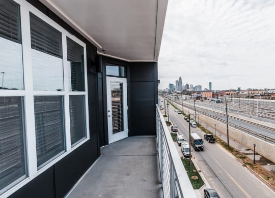a balcony with a view of the city  at Abberly Noda Vista Apartment Homes, Charlotte, NC, 28206