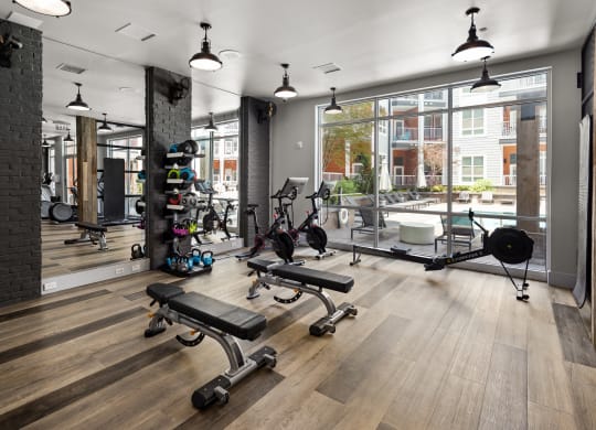 a workout room with weights and other exercise equipment at the casey, 2100 delgany  at Abberly Noda Vista Apartment Homes, Charlotte