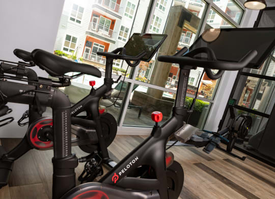 a row of exercise bikes in a gym  at Abberly Noda Vista Apartment Homes, Charlotte, NC
