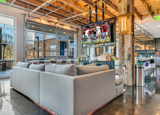 a living room filled with furniture and a flat screen tv  at Abberly Noda Vista Apartment Homes, Charlotte, North Carolina