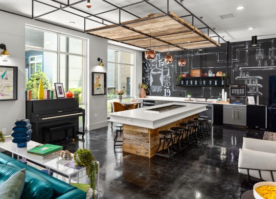 a kitchen with a large island and a piano at Abberly Noda Vista Apartment Homes, North Carolina