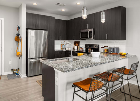 kitchen with granite countertops at the enclave at woodbridge apartments in sugar land, tx  at Abberly Noda Vista Apartment Homes, North Carolina, 28206