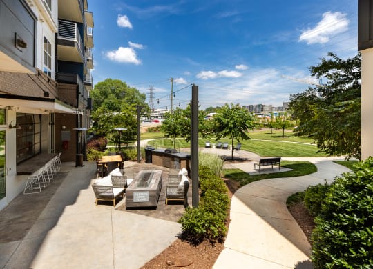 a patio with a fountain and seating area at the enclave at woodbridge apartments in sugar land  at Abberly Noda Vista Apartment Homes, North Carolina, 28206