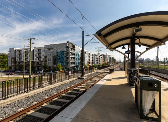 a train station with buildings in the background  at Abberly Noda Vista Apartment Homes, North Carolina, 28206