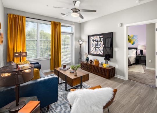 our apartments offer a living room with a couch coffee table and tv  at Abberly Noda Vista Apartment Homes, Charlotte, NC, 28206