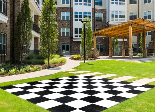 a black and white checkered sidewalk in front of an apartment building