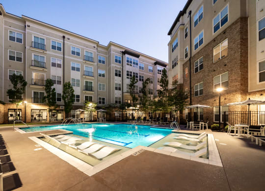an apartment complex with a swimming pool  at Abberly Onyx Apartment Homes, Georgia, 30033