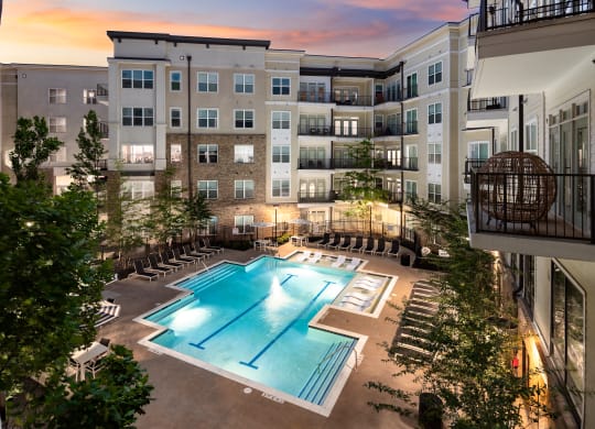 an apartment complex with a swimming pool  at Abberly Onyx Apartment Homes, Georgia