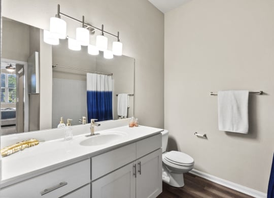 a bathroom with a large mirro at West Ashley Apartment Homes, Charleston, South Carolina 29414
