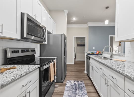 a kitchen with white cabinets and black appliances at West Ashley Apartment Homes, Charleston, South Carolina 29414