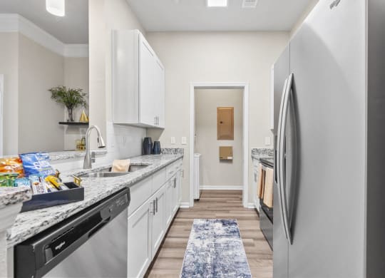 a kitchen with white cabinets at West Ashley Apartment Homes, Charleston