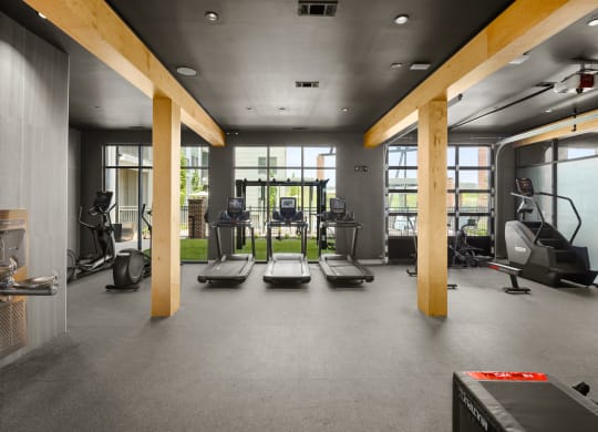 a spacious fitness room with cardio machines and weights at Abberly Riverwalk Apartment Homes, Nashville, TN, 37228