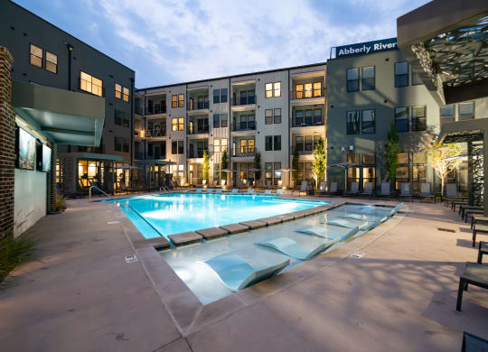 an apartment complex with a swimming pool in front of it at Abberly Riverwalk Apartment Homes, Nashville, 37228