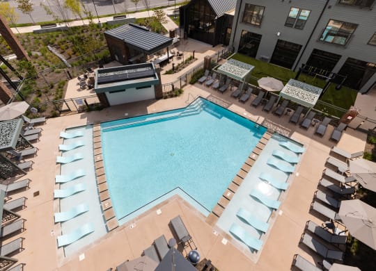 an aerial view of a resort style pool with lounge chairs and umbrellas at Abberly Riverwalk Apartment Homes, Nashville, TN, 37228