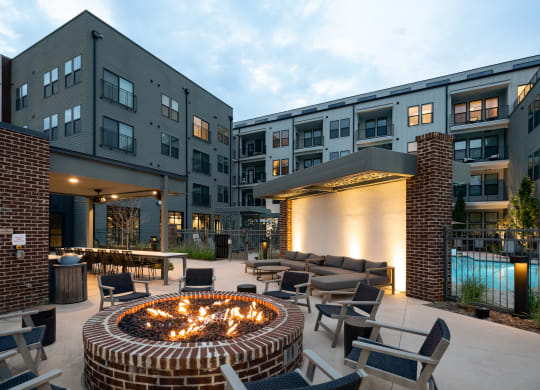 an outdoor patio with a fire pit and lounge chairs at Abberly Riverwalk Apartment Homes, Nashville, TN