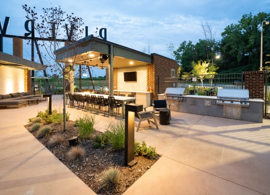 a patio with a grill and a table and chairs at Abberly Riverwalk Apartment Homes, Tennessee, 37228