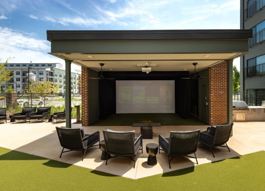 a large outdoor stage with chairs and a table in front of a large projection screen at Abberly Riverwalk Apartment Homes, Nashville, 37228