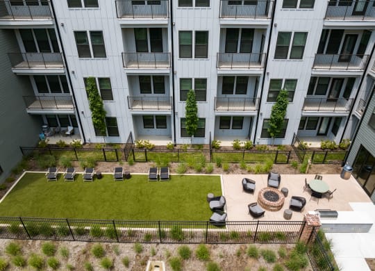 an aerial view of an apartment building with a lawn and fire pit at Abberly Riverwalk Apartment Homes, Nashville, 37228