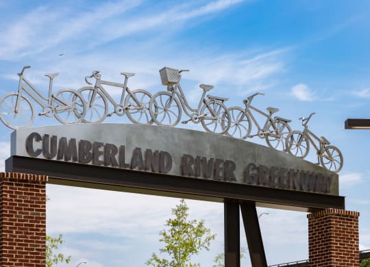 a sign for the cumberland river greenway with bikes on top of it at Abberly Riverwalk Apartment Homes, Nashville