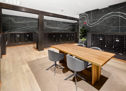 a conference room with a wooden table and grey chairs in front of a large blackboard with at Abberly Riverwalk Apartment Homes, Nashville