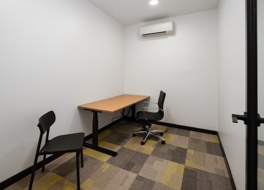 a small room with a table and two chairs