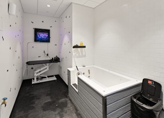 a bathroom with a bathtub and a tv on the wall at Abberly Riverwalk Apartment Homes, Tennessee, 37228