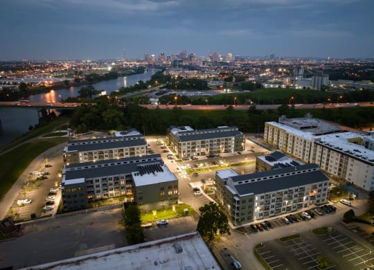 a cityscape at night with a river and a city skyline in the background  at Abberly Riverwalk Apartment Homes, Nashville, 37228