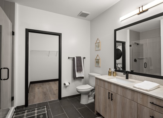 a bathroom with white walls and a black and white tiled floor  at Abberly Riverwalk Apartment Homes, Nashville, TN, 37228