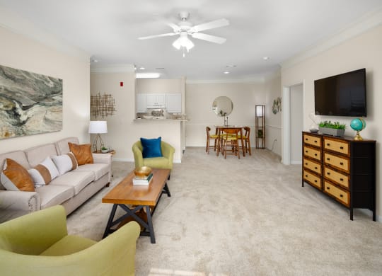 a living room with beige carpet and a ceiling fan at Abberly Grove Apartment Homes, North Carolina, 27610